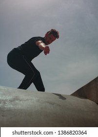 Male Movement Artist Dancing In An Empty Skatepark, Casting A Shadow Into The Skate Pool, From Where The Photo Is Shot.