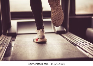 Male muscular feet in sneakers running on the treadmill. - Shutterstock ID 1112101931