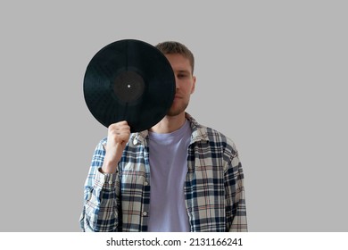 Male Music Lover Holding A Black Vinyl Record And Cover His Face 