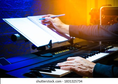 Male Musician, Composer Playing Piano And Writing A Hit Song In Home Studio. Song Writing Concept