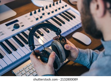 Male musician creates music using computer and keyboard, musician workplace. - Powered by Shutterstock