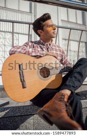 Similar – Young musician enjoying guitar on sunny day