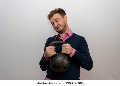 A Male Nerd 35-38 Years Old Is Trying To Lift A Heavy Weight On A Light Background.