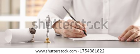 Male notary working with documents at table in office, closeup. Banner design