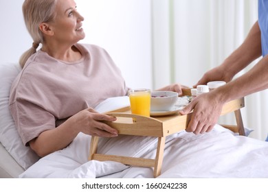 Male Nurse Bringing Food And Medicine For Patient In Hospital Ward, Closeup. Doctor's Prescription