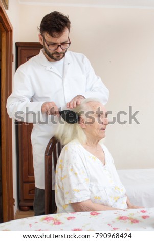 Similar – Image, Stock Photo Caregiver helping elderly female patient to get out of bed