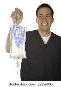 A Male Nurse Holding Out A Bag Of IV Fluids