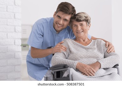 Male nurse hugging his senior woman patient sitting on a wheelchair - Shutterstock ID 508387501