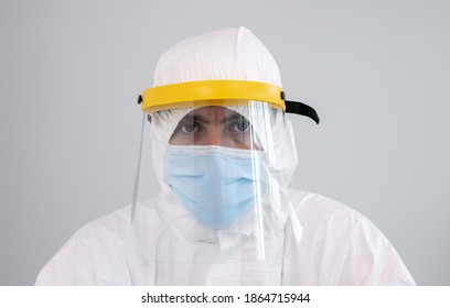 A Male Nurse In A Protective Suit PPE And Face Mask Looking Straight Ahead. Coronavirus Pandemic Caused By Covid 19.