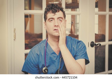 Male nurse in scrubs with stethoscope is tired from exams - Powered by Shutterstock