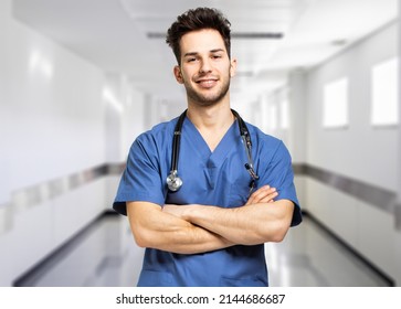 Male Nurse Smiling In A Hospital Hallway