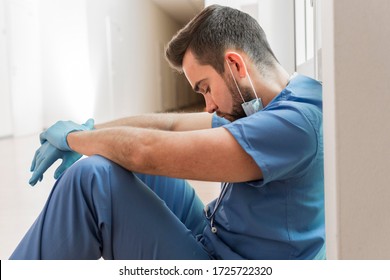 Male nurse tired after a long day at work - Powered by Shutterstock