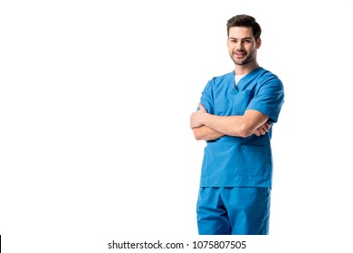 Male nurse wearing blue uniform standing with folded arms isolated on white