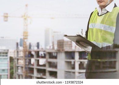 Male Occupational Health And Safety Officer Inside Factory Doing Inspection With Light Effect