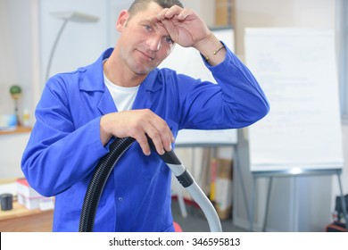 Male Office Cleaner Wiping His Brow