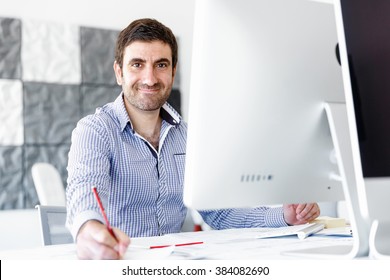 Male Office Worker Sitting At Desk