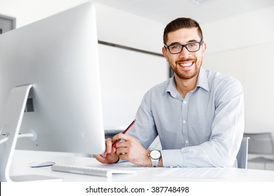 Male Office Worker Sitting At Desk