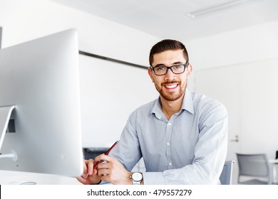 Male Office Worker Sitting At Desk