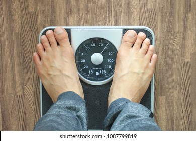 Male on the weight scale for check weight, Diet concept - Shutterstock ID 1087799819