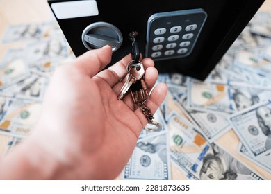 Male open with keys lock safe door against dollar money. - Shutterstock ID 2281873635