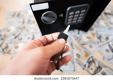Male open with keys lock safe door against dollar money. - Shutterstock ID 2281873647