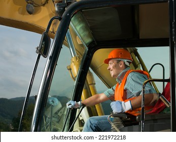 male operator driving excavator on construction building site - Powered by Shutterstock