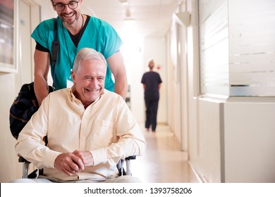 Male Orderly Pushing Senior Male Patient Being Discharged From Hospital In Wheelchair - Powered by Shutterstock