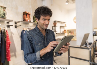 Male Owner Of Fashion Store With Digital Tablet Computer