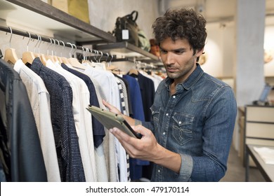 Male Owner Of Fashion Store With Digital Tablet Computer