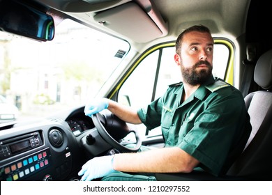 Male Paramedic Driving An Ambulance