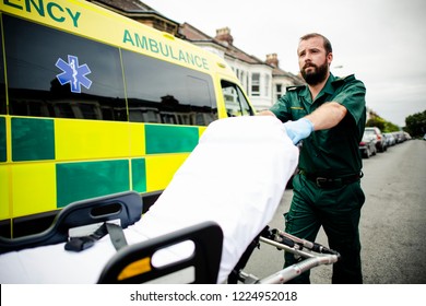 Male Paramedic Moving The Ambulance Stretcher