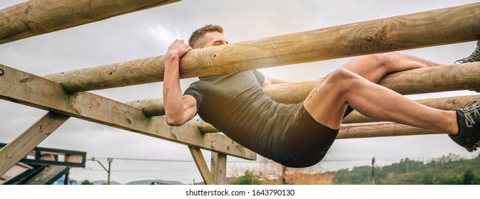 Male participant in a obstacle course doing weaver obstacle