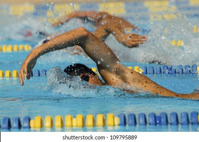 Male participants competing in a swimming race