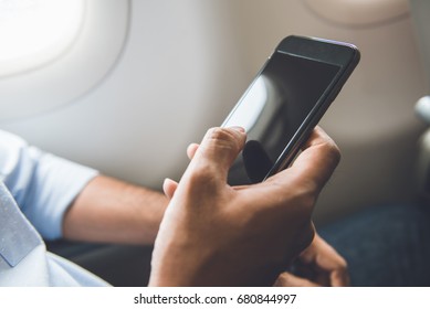 Male Passenger Just Turned Off Mobile Phone On The Airplane While Traveling For Safe Flight