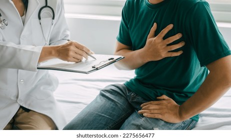 Male patient consulting a medical specialist at hospital. Chest pain and inflammatory heart disease