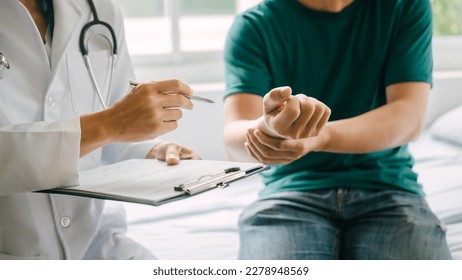 Male patient consulting a medical specialist at hospital. wrist pain - Shutterstock ID 2278948569