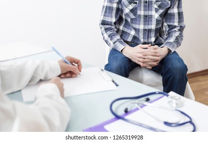 A male patient consults with a doctor about prostate cancer or some other disease. 