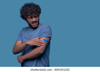 Male Patient Experiencing Arm Pain At The Injection Site