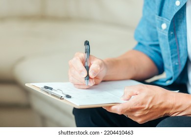 Male Patient Filling Out A Medical Questionnaire