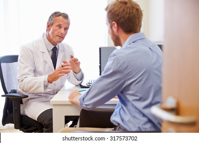 Male Patient Having Consultation With Doctor In Office