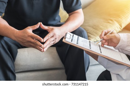 Male Patient Having Consultation With Doctor Or Psychiatrist Who Working On Diagnostic Examination On Men's Health Disease Or Mental Illness In Medical Clinic Or Hospital Mental Health Service Center