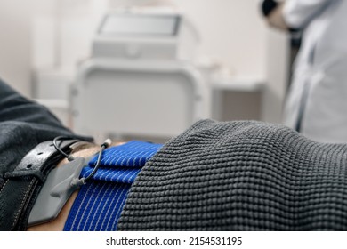 Male Patient Having Spinal Traction Procedure In Medical Clinic