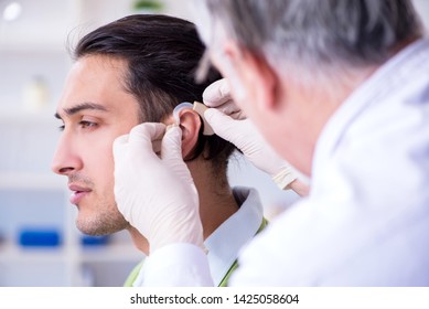 Male Patient With Hearing Problem Visiting Doctor Otorhinolaryng