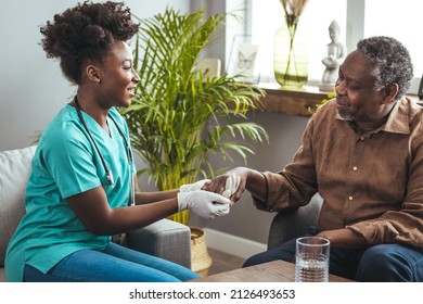 Male patient holding hands with a nurse. Nurse holding hand of senior man in rest home. Doctor helping old patient with Alzheimer's disease. Shot of a caregiver helping a senior man.  - Powered by Shutterstock