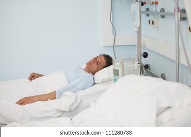 Male Patient Lying On A Medical Bed In Hospital Ward