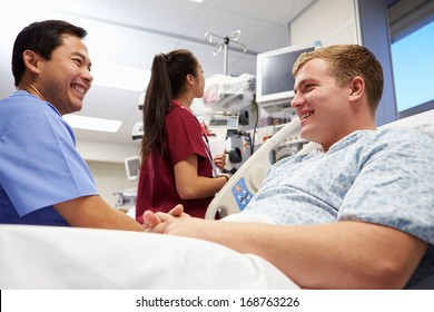 Male Patient Talking To Medical Staff In Emergency Room