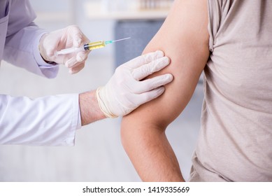 Male Patient Visitng Doctor For Shot Inoculation 