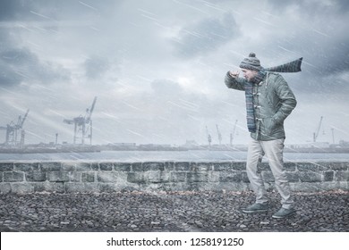 Male Pedestrian Is Facing Strong Wind And Rain