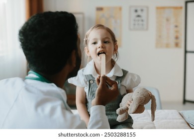 Male Pediatrician examining throat of a little ill girl.
 - Powered by Shutterstock