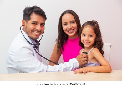 Male Pediatrics Examine Girl Child With Stethoscope To Check Lung And Heart. Mother Takes Little Girl To Pediatrics.